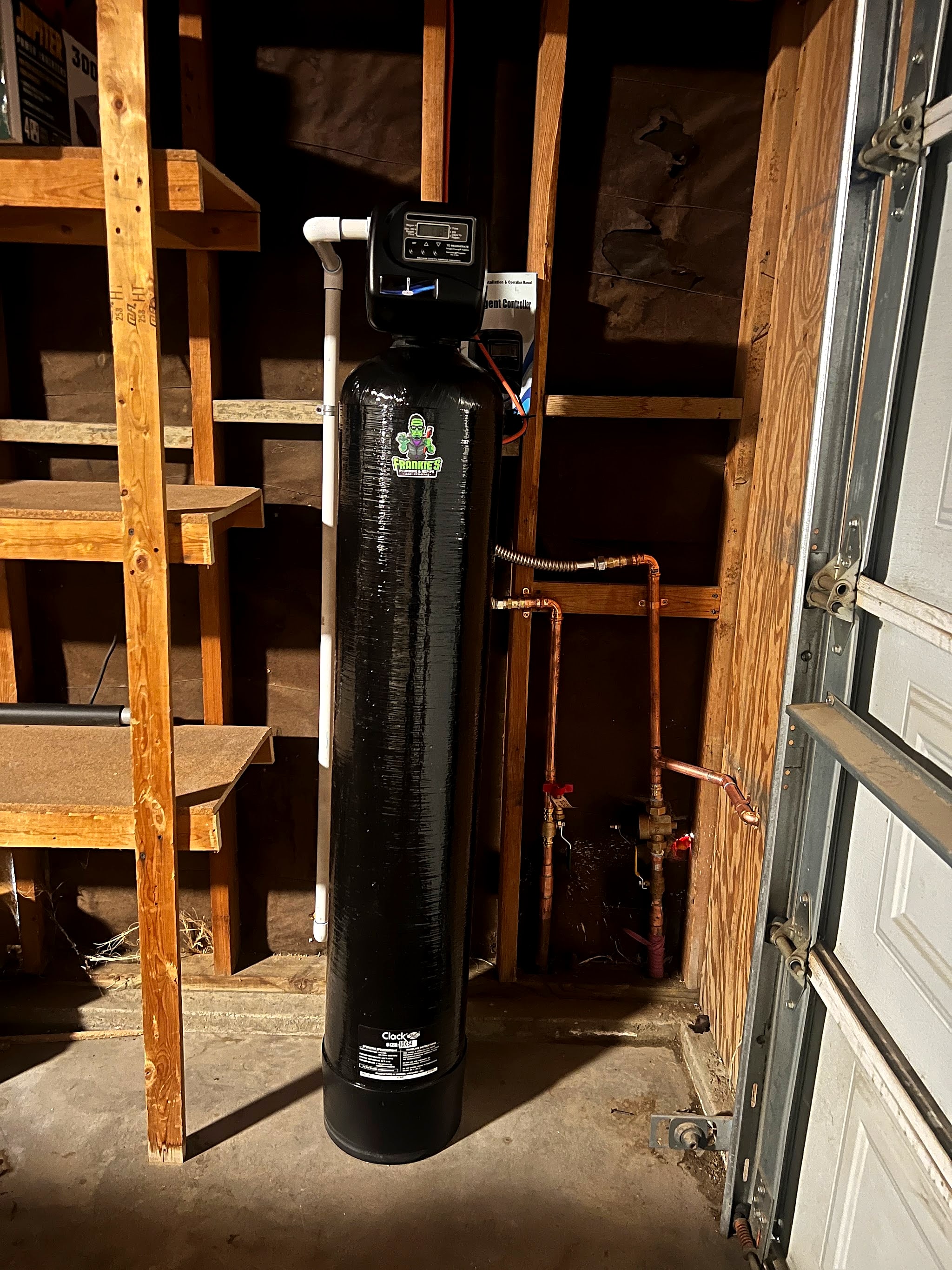 Whole-house water filtration tank installed in a garage
